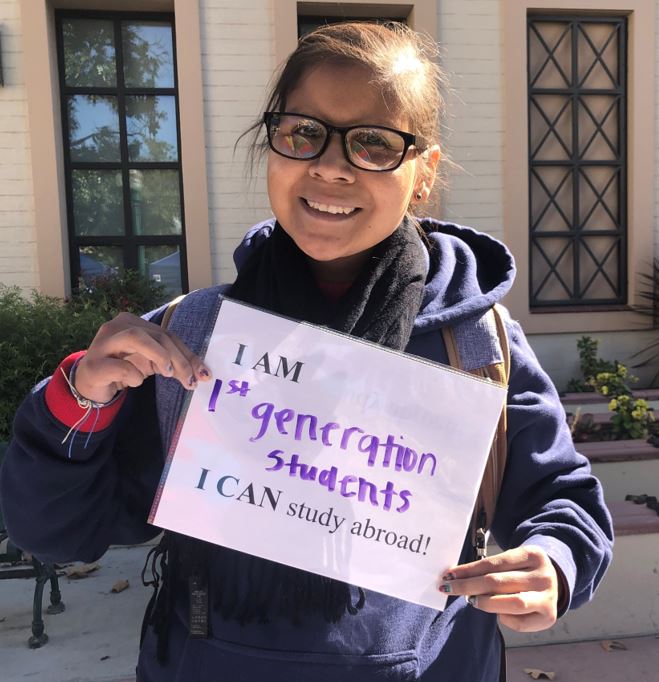 Student with I can Study Abroad sign